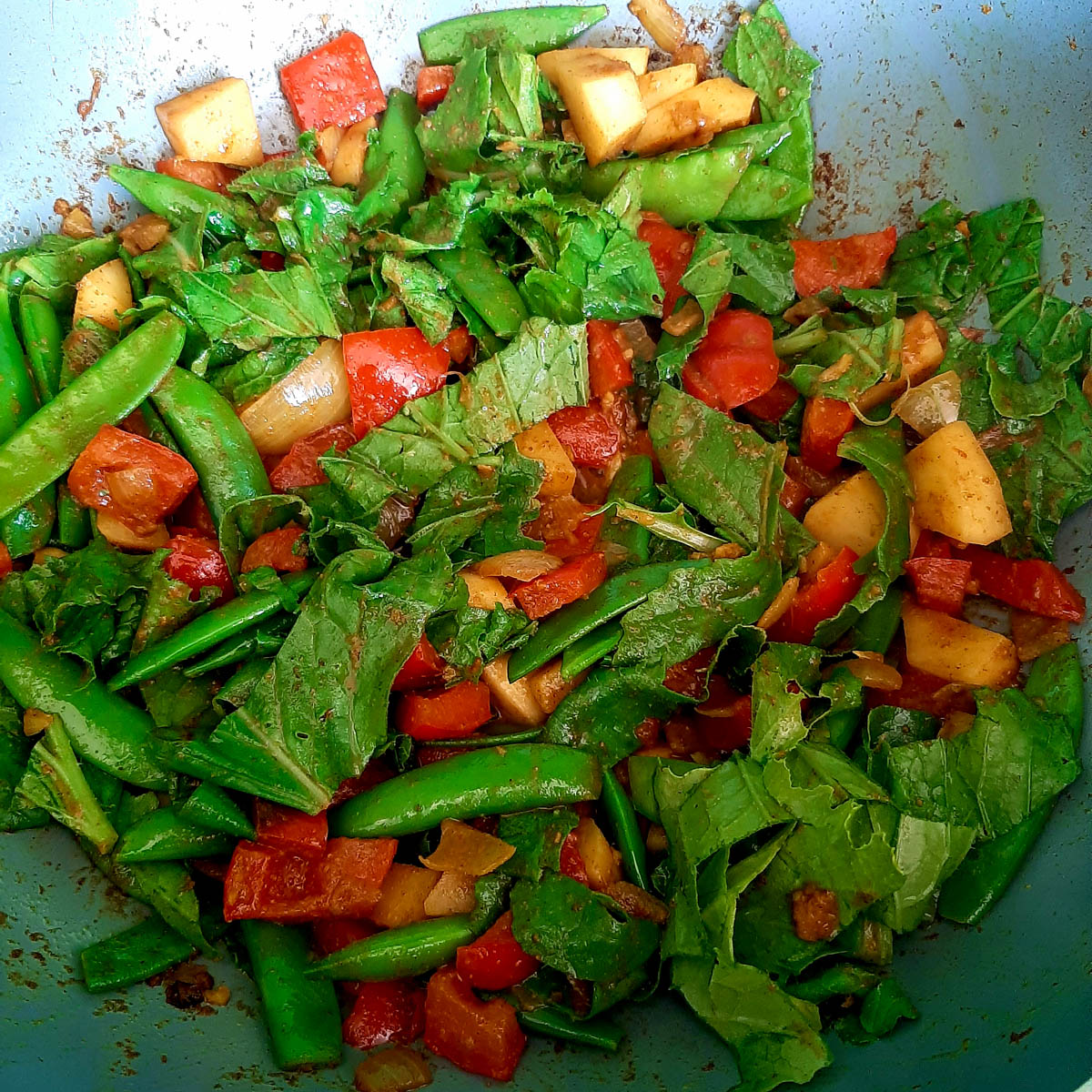 Turnips, snow peas, sugar snaps and peppers in the pan